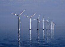 Landscape photograph of a wind farm over water