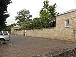 Inside the university grounds, i.e. the former Drostdy grounds, is another old building which recalls the tempestuous years of 1835 to 1842 when the Governor of the Cape Colony decided to use the Drostdy and the surrounding area in the defence. Type of site: Military. Cape Parliament sat in this building in 1864. Earlier a military hospital from the 1830s.