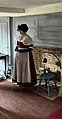 A period reenactor in the house's west parlor