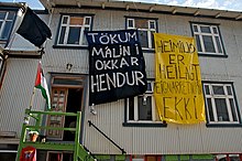 A short-lived squat in Reykjavik in 2009. The signs say "We take matters into our own hands" and "The home is sacred, the property rights are not" Reykjavik Squat, Iceland (3446319888).jpg