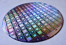 A wafer of adiabatic quantum computers A Wafer of the Latest D-Wave Quantum Computers (39188583425).jpg