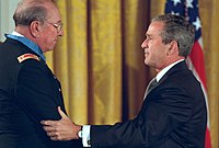 Ed Freeman (left) is congratulated by President George W. Bush after receiving his award