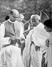 Mahadev Desai (left) reading out a letter to Gandhi from the viceroy at Birla House, Bombay, April 7, 1939