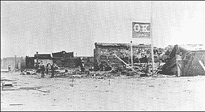 After the May 25, 1882, fire, the only remnant of the O.K. Corral was its sign. The blaze destroyed most of the western half of the business district. Tombstone fire 1882.jpg