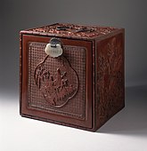 Japanese chest with a cartouche showing figures on donkeys in a landscape; 1750–1800; carved red lacquer on wood core with metal fittings and jade lock; 30.64 × 30.16 × 12.7 cm; Los Angeles County Museum of Art (USA)