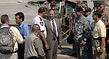 In the center, Donald C. Winter, former Secretary of the Navy, views the I-35W bridge collapse site. To the left is Minnesota Governor Tim Pawlenty. Donald C Winter Tours 35W Bridge Collapse site.jpg