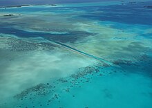 Artificially made German Channel is one of the most popular dive sites. It is also a major transport route for boats that connects the lagoon to the Pacific Ocean in the south-west. German-Channel-2016-aerial-view-Luka-Peternel.jpg