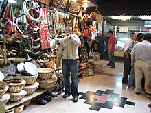 Market stall selling trutrucas and kultrunes along with other Mapuche craft items (individual is playing a trutruca) Tocando la trutruca.jpg