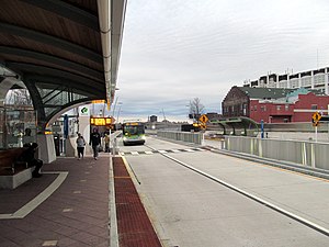 A bus approaching a bus station in an urban area