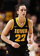 Woman running in basketball uniform