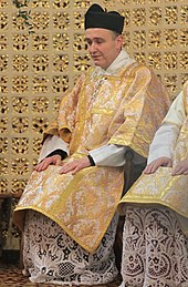 A Catholic deacon wearing his dalmatic and biretta Deacon dalmatic 20100418.jpg