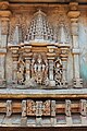 Decorative miniature decorative towers over deity relief sculpture on outer wall of Chennakeshava temple at Hullekere