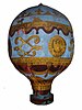 Picture of a model of a hot air balloon, which has a blue background and is decorated with gold.