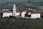 Aerial view of the abbey, which is surrounded by forest
