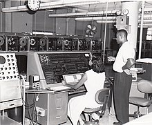 Census Bureau employees tabulate data using one of the agency's UNIVAC computers, c. 1960. Univac I at Census Bureau with two operators.jpg
