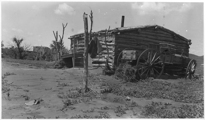 File:Log cabin with wagon parked beside it - NARA - 285822.tif