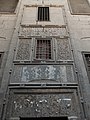 The decoration on the exterior wall above the mosque's rear entrance doors.