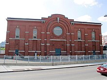 In continuous operation since 1901, the Adelard-Godbout substation in Old Montreal is Canada's oldest substation. It has a facade in clay brick with gray stone ornaments to blend in to its downtown environment. Poste Adelard-Godbout 06.JPG