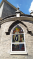 Exterior view of one of the new windows. This window shows the Apparition of Blessed Virgin Mary to St. Bernadette Soubirous in Lourdes.