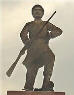 A statue of Phan Đình Phùng which is located in center of the traffic circle facing the Cho Lon General Post Office, District 5, Ho Chi Minh City.