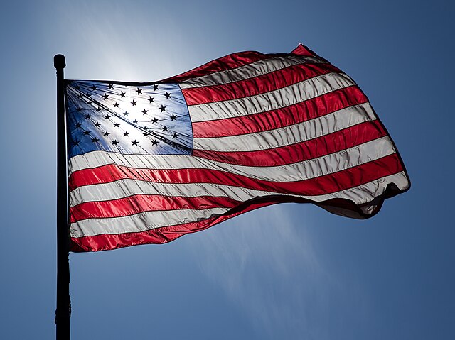 American flag backlit waving