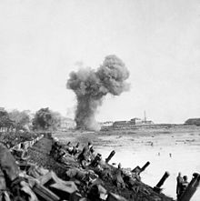 British assault troops advancing near Flushing with shells bursting ahead during the Scheldt operation. British Landings on Walcheren BU1255.jpg