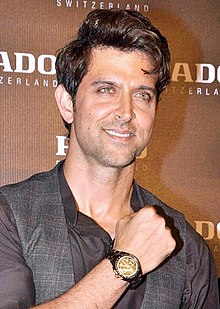 A photograph of Hrithik Roshan smiling away from the camera.