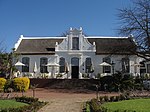 This property was originally granted to Barend Lubbe in 1699. The present H-shaped gabled house with its impressive facade was erected in 1814 by Charles Marais.