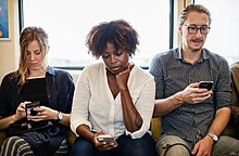 People using their smartphones People concentrating on phones.jpg