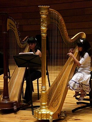 English: Two girls playing the classic harp, C...