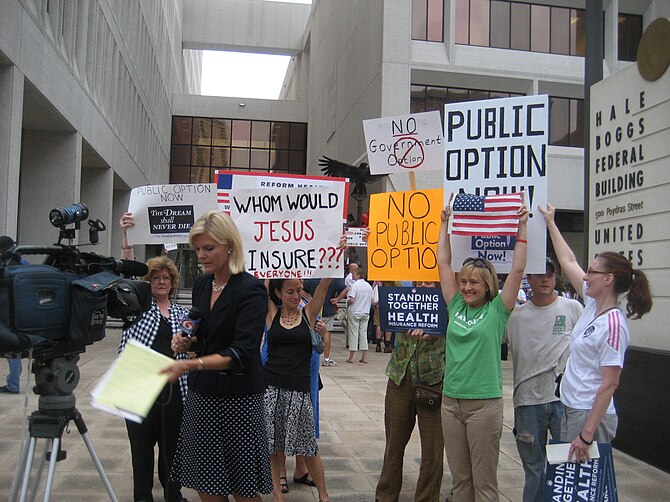 Pro and anti healthcare protesters vie for spa...