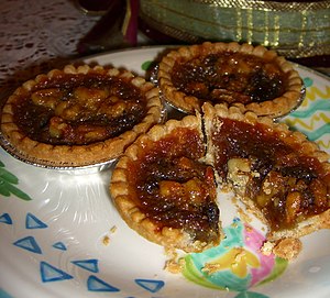 Three butter tarts on a plate, with flash