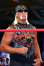 Hulk Hogan standing while holding a microphone, during a TNA Impact! taping