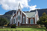 Very fine Cape Gothic dressed stone church with white plaster detailing. Decoration is unusually 'spiky'. This church in the Neo-Gothic style, was designed by Carl Otto Hager. The foundation stone was laid on 12 August 1880. The building was completed early in 1882 and was officially inaugurated on 28 April. Type of site: Church Current use: Church : Dutch Reformed.