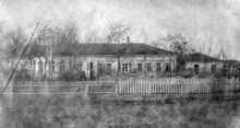 Photograph of a single story wooden farmhouse