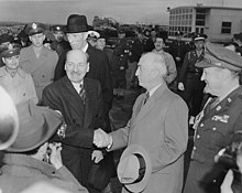 The prime minister, Clement Attlee, shakes hands with the United States Secretary of State James F. Byrnes on 10 November 1945 Photograph of British Prime Minister Clement Attlee shaking hands with Secretary of State James Byrnes upon his... - NARA - 199245.jpg