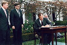 Barr and Dan Quayle watch as President George H. W. Bush signs the Civil Rights Commission Reauthorization Act in the Rose Garden of the White House in 1991. President George H. W. Bush signs the Civil Rights Commission Reauthorization Act in the Rose Garden of the White House.jpg