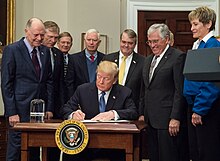 President Trump signs Space Policy Directive 1 on December 11, 2017, with astronauts Harrison Schmitt, Buzz Aldrin, Peggy Whitson, and Christina Koch looking on. Presidential Space Directive - 1 Signing (NHQ201712110001).jpg
