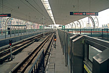 Cross-platform interchanges between different train categories in Xipu Railway Station, Chengdu. The double track of Line 2 of Chengdu Metro is in the middle, while the double tracks of national rail transport system (Chengdu-Dujiangyan intercity railway) are on both sides. Xipu Metro Line.jpg