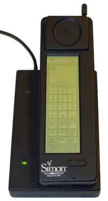 Photograph of the Simon Personal Communicator shown in its charging base