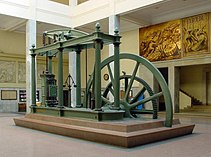 A Watt steam engine in Madrid. The development of the steam engine started the industrial revolution in England. The steam engine was created to pump water from coal mines, enabling them to be deepened beyond groundwater levels. Maquina vapor Watt ETSIIM.jpg