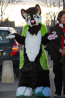 A person in an animal costume shrugs shoulders, palms up.