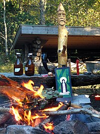 Heathen altar for Haustblot in Bjorko, Sweden. The larger wooden idol represents the god Frey. Sveriges Asatrosamfunds hostblot 2009.jpg