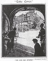 Women hiding in a wide darkened doorway. They look out through the building at a street, deserted except for a single policeman who gestures for them not to leave the building.