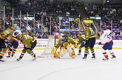 The Barrie Colts applying pressure at the Brampton Battalion net in an ice hockey game.