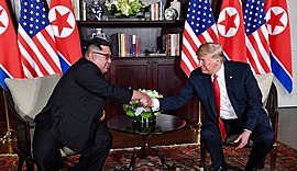 Trump and Kim shaking hands in the summit room.jpg