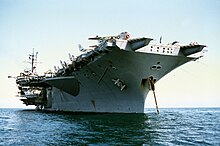 A waterline view of USS America, 1982. USS America (CV-66) low view of stbd bow.jpg