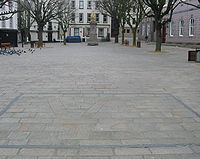During the German occupation of Jersey, a stonemason repairing the paving of the Royal Square incorporated a V for victory under the noses of the occupiers. This was later amended to refer to the Red Cross ship Vega. The addition of the date 1945 and a more recent frame has transformed it into a monument.