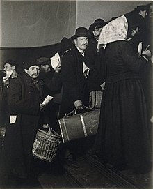 "1905. Here is a Slavic group waiting to get through entrance gate. Many lines like these were prevalent in the early days. There was no room to keep personal belongings, so the immigrants had to carry their baggage with them all the time." (photo by Lewis Hine) Brooklyn Museum - Climbing into the Promised Land Ellis Island - Lewis Wickes Hine.jpg