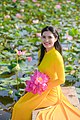 A woman wearing yellow áo dài, May 2021